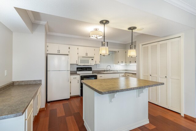 kitchen with white appliances, dark wood-type flooring, and ornamental molding