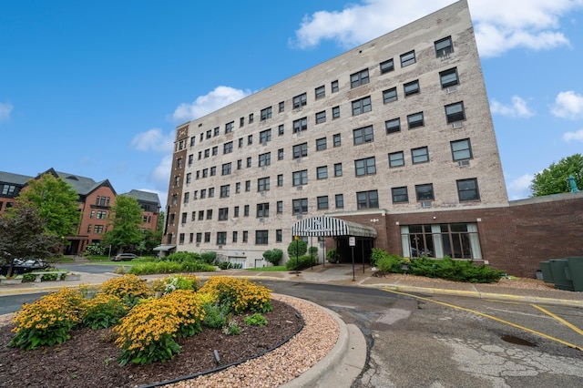 view of building exterior featuring uncovered parking