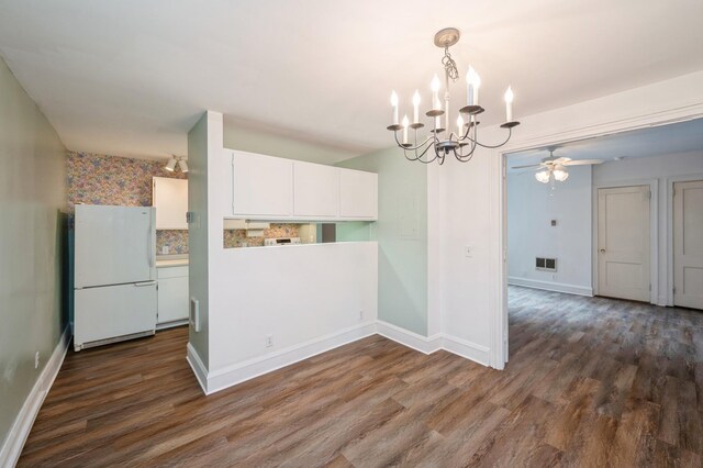 79 Western Ave N Unit 205, Saint Paul, MN 55102 - kitchen with freestanding refrigerator, a chandelier, dark wood-style flooring, and white cabinetry