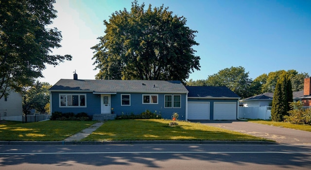 ranch-style house with a garage and a front yard