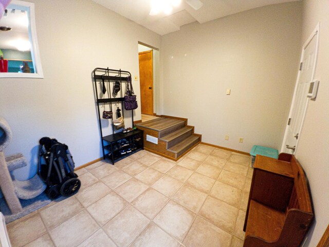 miscellaneous room with light tile patterned flooring and ceiling fan