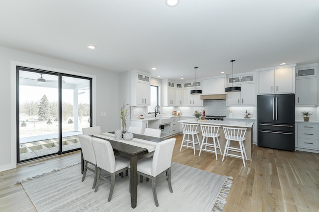 dining space with recessed lighting, visible vents, and light wood-style flooring