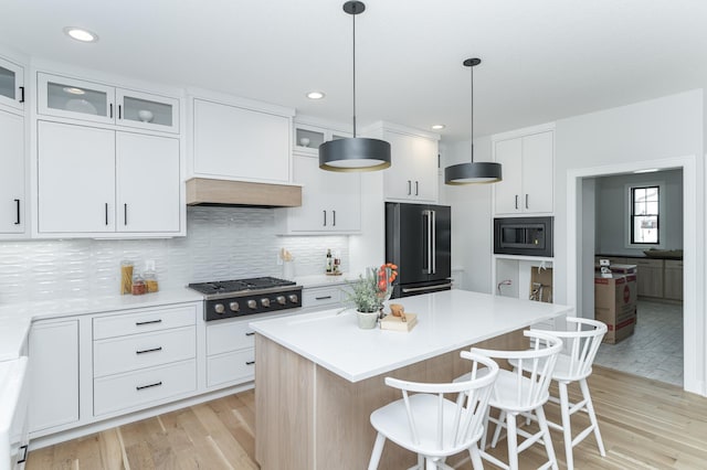 kitchen with light countertops, high end refrigerator, and white cabinetry