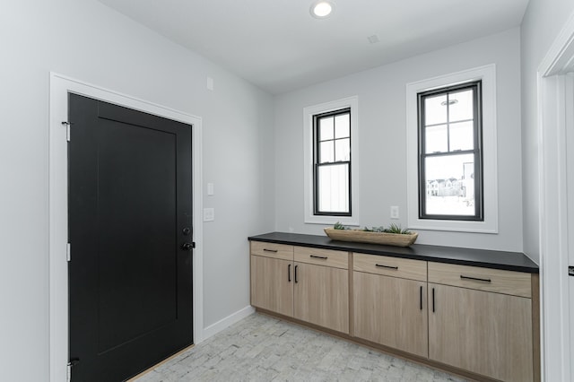 interior space featuring vanity and baseboards