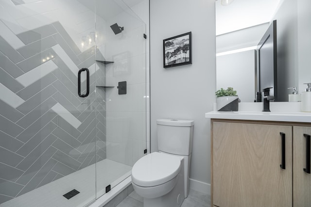 bathroom with a stall shower, vanity, toilet, and baseboards