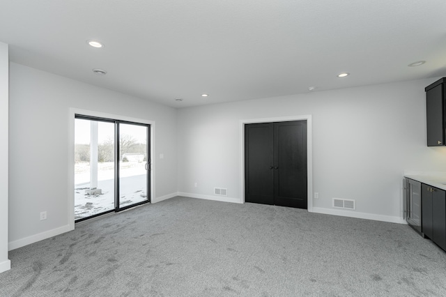 2643 Timber Oaks Rd SW, Rochester, MN 55902 - unfurnished living room featuring carpet, baseboards, and recessed lighting