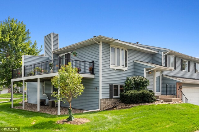 14797 Lower Endicott Way, Apple Valley, MN 55124 - view of side of property featuring a lawn, an attached garage, a chimney, and a balcony