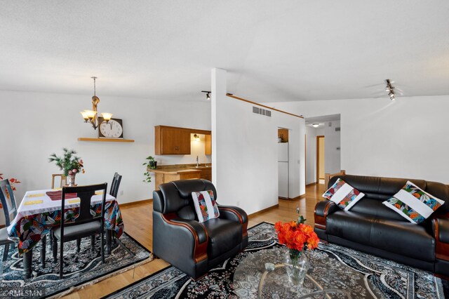 14797 Lower Endicott Way, Apple Valley, MN 55124 - living room featuring an inviting chandelier, wood finished floors, and visible vents
