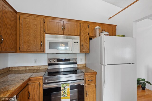 14797 Lower Endicott Way, Apple Valley, MN 55124 - kitchen featuring brown cabinets, tile countertops, and white appliances