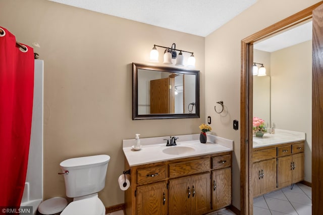 full bathroom with toilet, tile patterned floors, vanity, a textured ceiling, and shower / tub combo with curtain