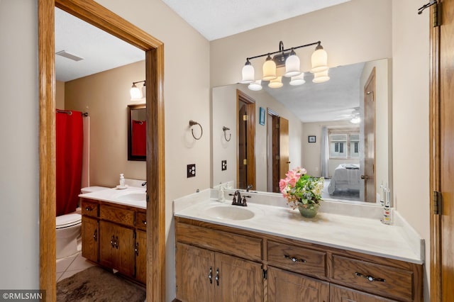 bathroom featuring a textured ceiling, vanity, toilet, and tile patterned floors