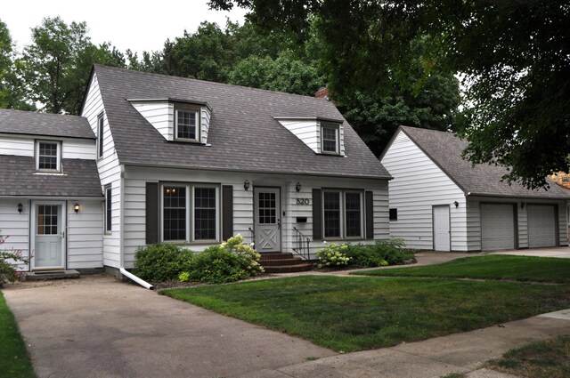 cape cod home featuring a garage and a front yard