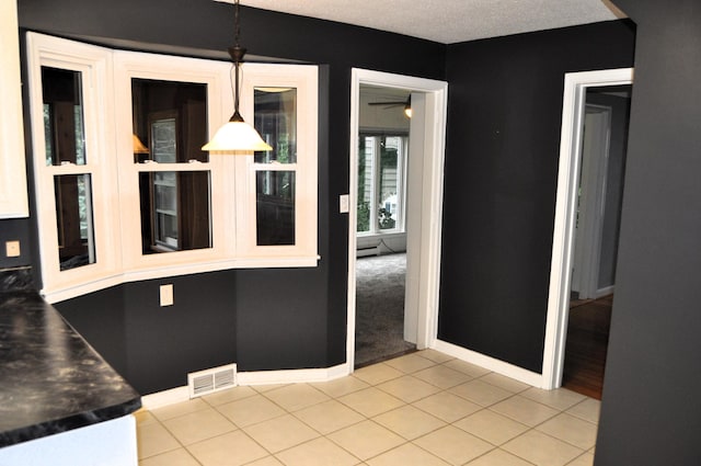 interior space featuring light tile patterned flooring and a baseboard heating unit