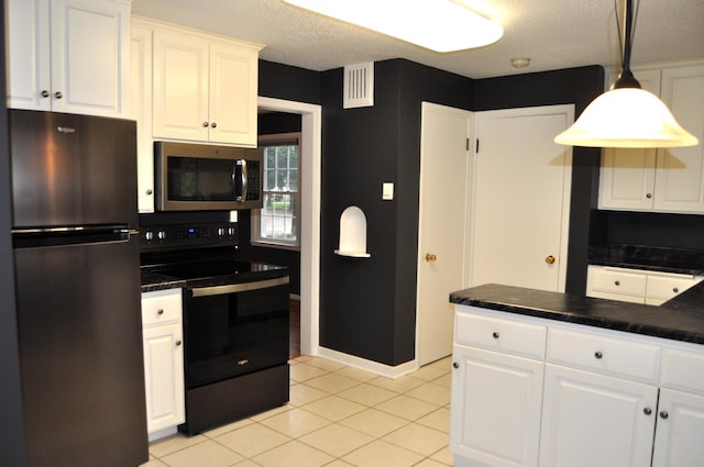 kitchen featuring appliances with stainless steel finishes, white cabinets, hanging light fixtures, and light tile patterned floors