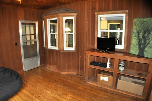 interior space featuring hardwood / wood-style flooring and wooden walls