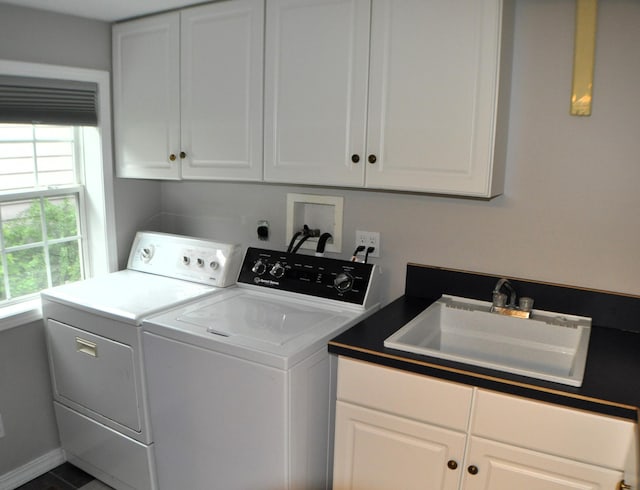 laundry room with sink, washer and clothes dryer, and cabinets