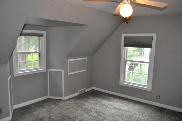 additional living space featuring carpet floors, vaulted ceiling, and ceiling fan