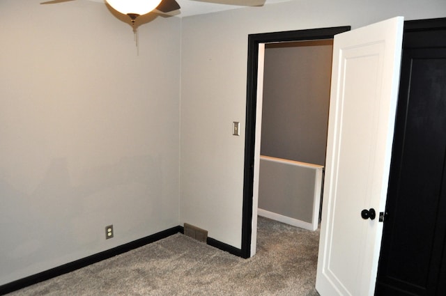 carpeted spare room with ceiling fan