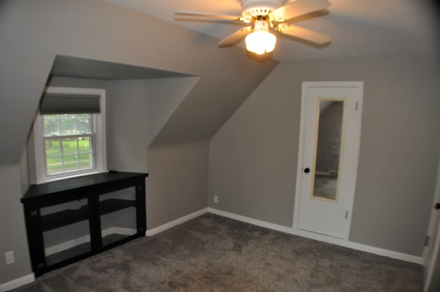 bonus room with lofted ceiling, dark colored carpet, and ceiling fan