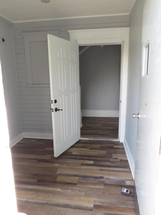 corridor with dark hardwood / wood-style flooring