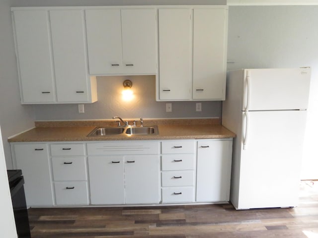 kitchen featuring white cabinetry, sink, dark wood-type flooring, and white refrigerator