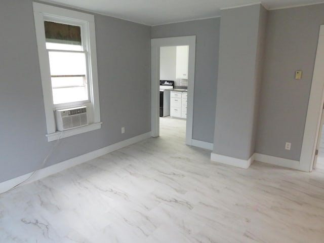 unfurnished room featuring cooling unit and ornamental molding