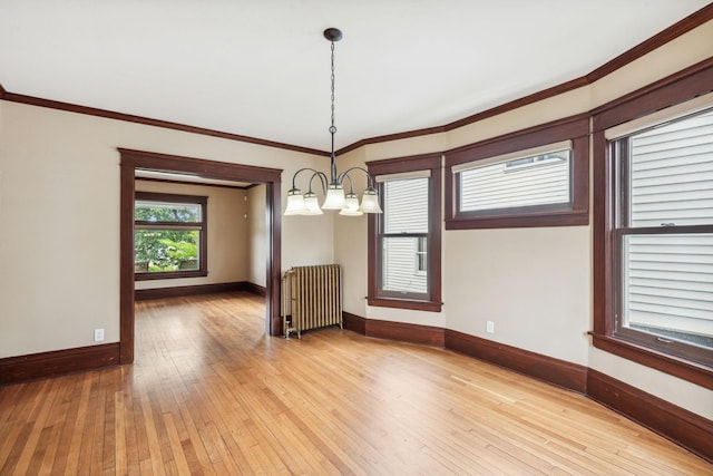 unfurnished dining area featuring a notable chandelier, crown molding, light hardwood / wood-style flooring, and radiator heating unit