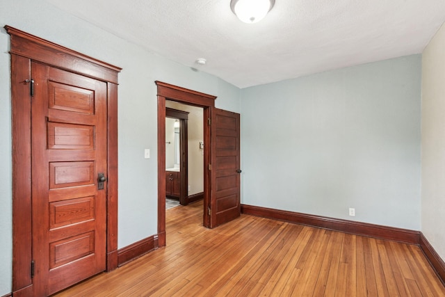 unfurnished room with light hardwood / wood-style floors