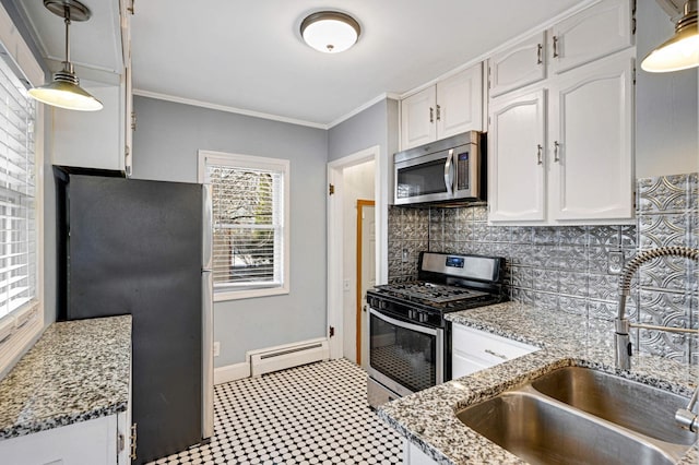 kitchen featuring appliances with stainless steel finishes, a baseboard heating unit, sink, white cabinetry, and hanging light fixtures