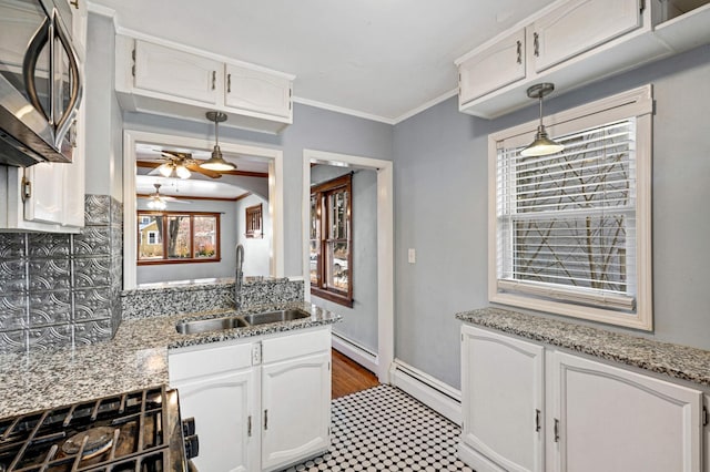 kitchen featuring white cabinetry, sink, a baseboard heating unit, crown molding, and stove