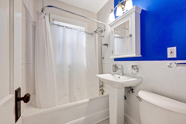 bathroom featuring shower / bath combination with curtain, tile walls, and toilet