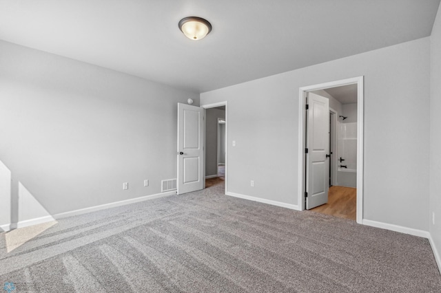 unfurnished bedroom featuring light carpet