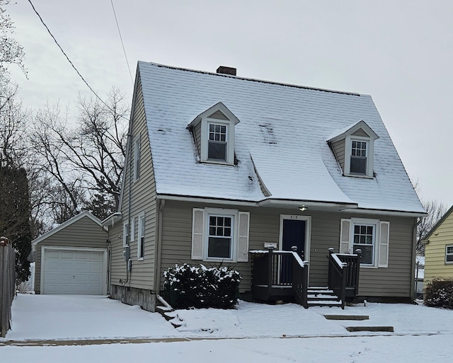 cape cod house with a garage and an outbuilding