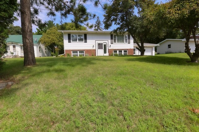 view of front of home featuring a garage and a front lawn