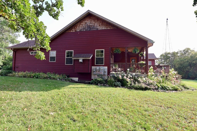 rear view of house featuring a yard