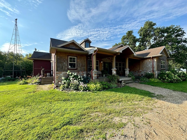 view of front facade featuring stone siding, a porch, and a front lawn