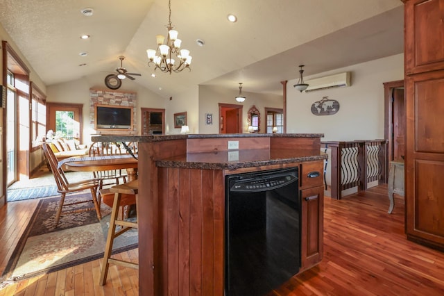 kitchen with dark wood finished floors, dishwasher, a wall unit AC, open floor plan, and vaulted ceiling