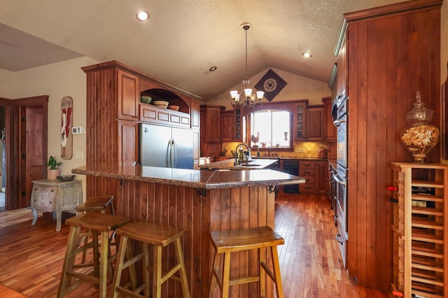 kitchen featuring open shelves, light wood finished floors, stainless steel appliances, and lofted ceiling