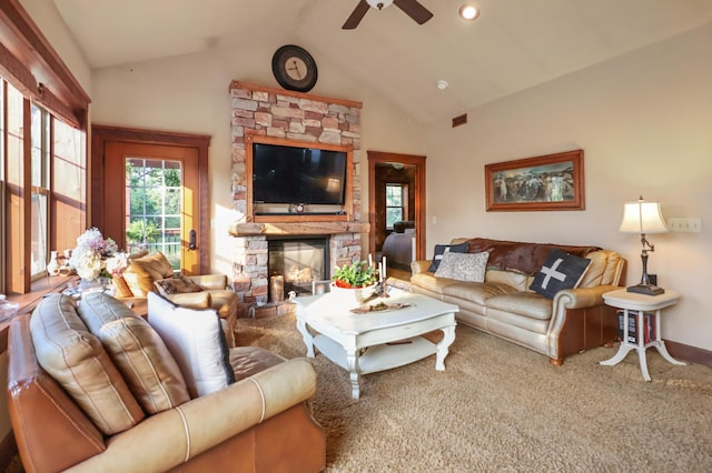 carpeted living room featuring a ceiling fan, lofted ceiling, visible vents, and a stone fireplace