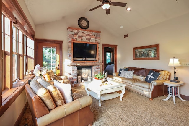 carpeted living room featuring high vaulted ceiling, a fireplace, visible vents, and a ceiling fan