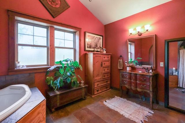 full bath with a tub, vaulted ceiling, and vanity