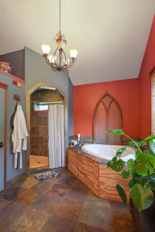 bathroom featuring lofted ceiling, a stall shower, a notable chandelier, and a bath