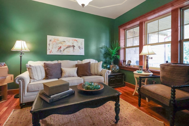 living area with wood finished floors and baseboards