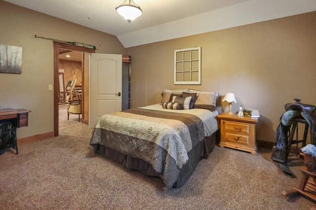 bedroom featuring lofted ceiling and carpet