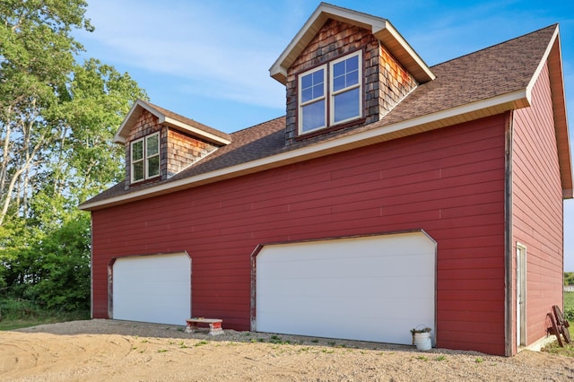 garage with dirt driveway