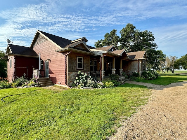 view of front of home featuring a front yard and stone siding