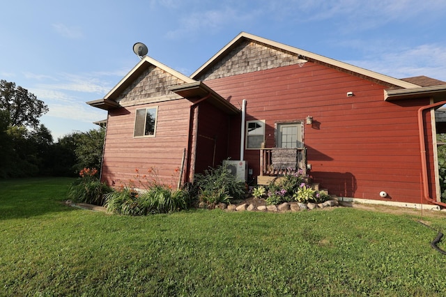 back of property featuring a yard