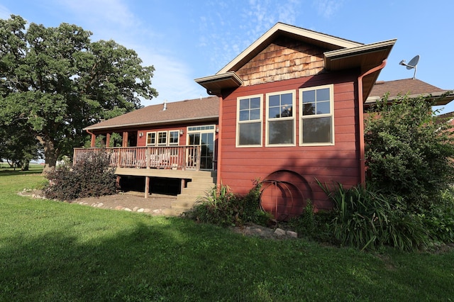 back of house featuring a lawn and a wooden deck