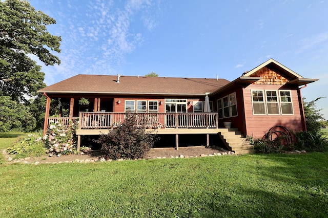 rear view of property featuring a yard and a wooden deck