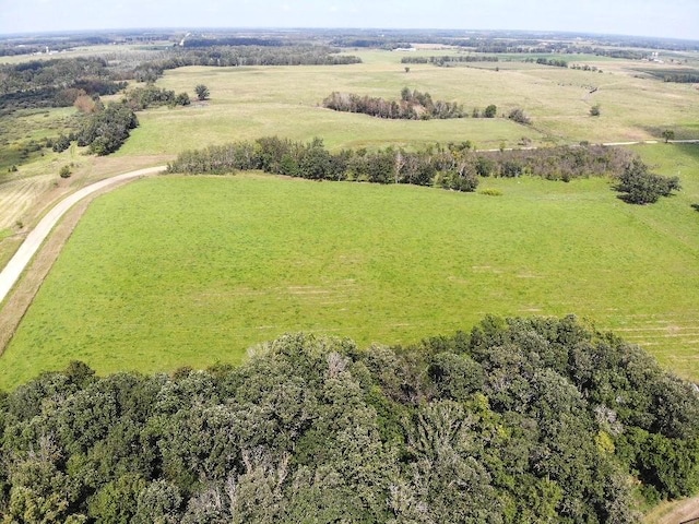 birds eye view of property with a rural view